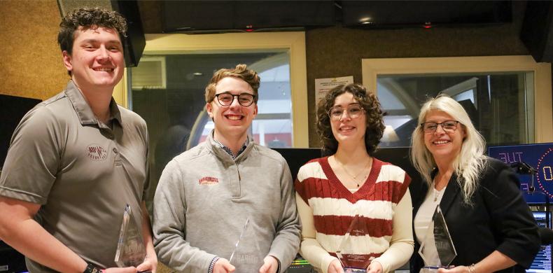 Four individuals are pictures holding their awards.